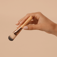 Woman holding the Purely Byron mask brush