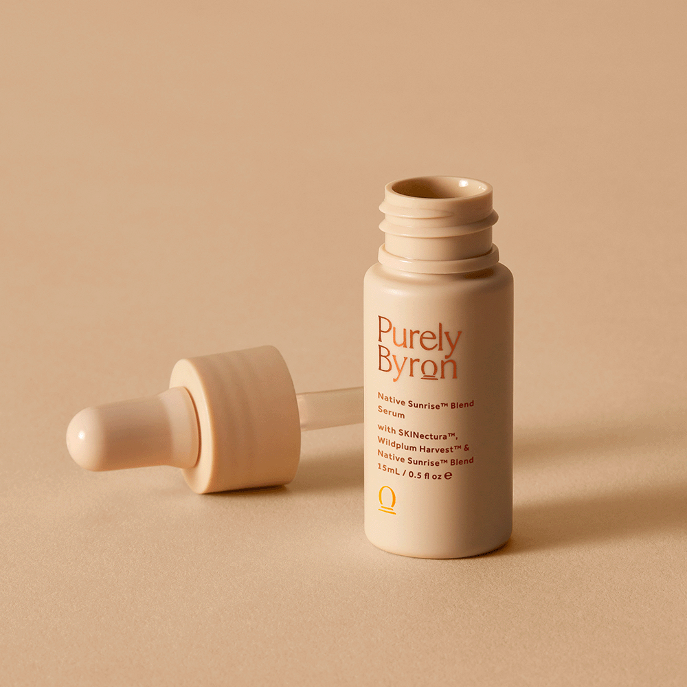 A bottle of the Native Sunrise™ Blend Serum opened, with the dropper laying on the side