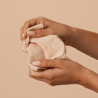 Woman gently holding the Purely Byron Cotton Muslin cloth